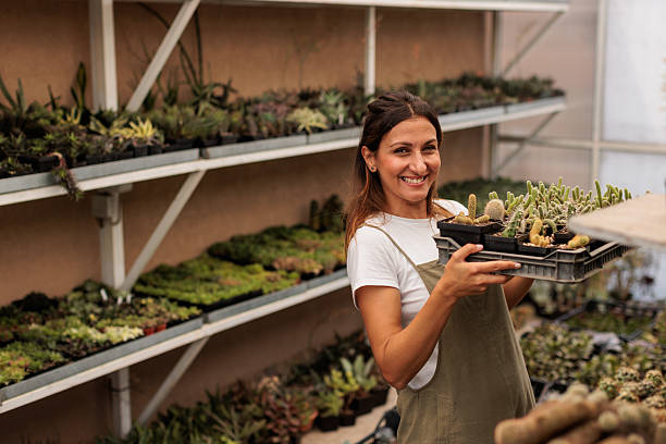 istock Smiling Female Botanist in Greenhouse 2246193126