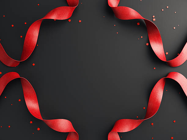 Red satin ribbon on a black background with confetti — simple, elegant, and festive.
