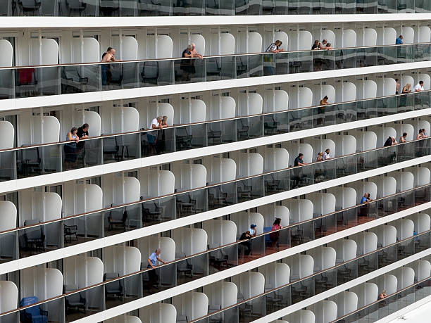 BASSETERRE, ST KITTS / ST KITTS AND NEVIS - FEBRUARY 01, 2025: Passengers stand on balconies, Norwegian Viva cruise ship moored at St Kitts