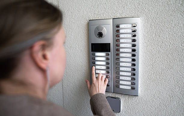 istock Woman rings the intercom from the street. 2246195201