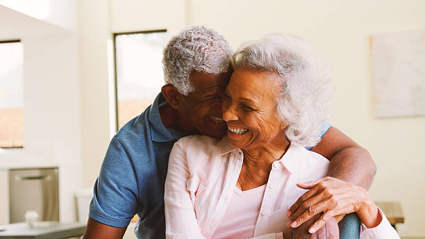 istock Loving Senior Couple Sitting On Sofa At Home Together 2246198301