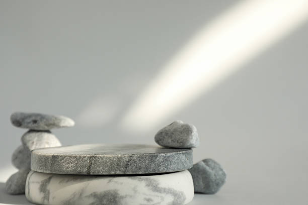 istock Presentation for product. Stone podium and pebbles on light grey background. Space for text 2246199722