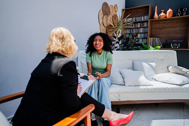 istock Young woman receiving emotional support during therapy session 2246200247