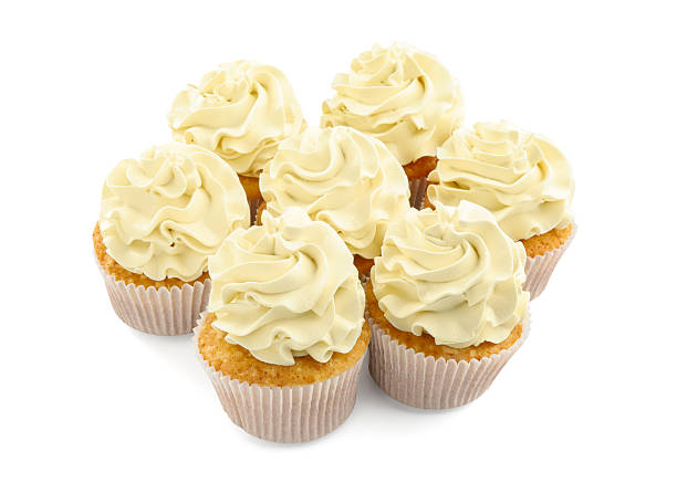 istock Tasty vanilla cupcakes with cream isolated on white 2246201331