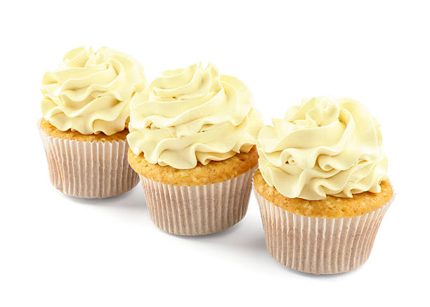 istock Tasty vanilla cupcakes with cream isolated on white 2246201433