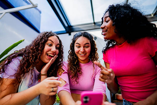 istock Friends sharing funny moment on smartphone 2246201443
