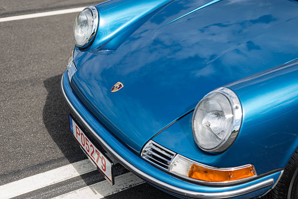 Vilnius, Lithuania - August 10, 2023: Side view of 1971 Porsche 911T Targa in a metallic blue. Car parked in the middle of a closed four lane road. Car is in perfect condition, after full restoration.