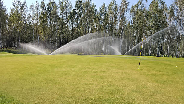 istock Golf course irrigation system in action during bright daylight on a lush green fairway concept 2246202981