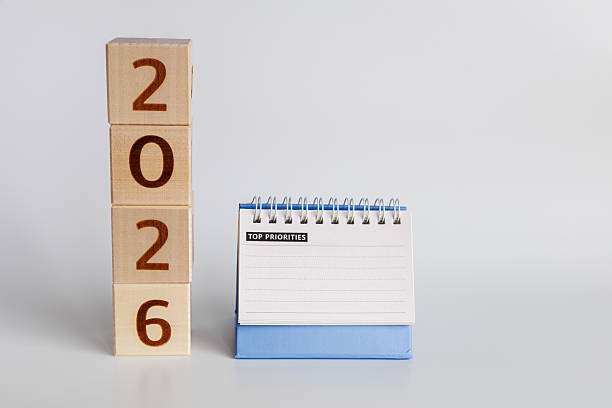 istock Blocks showing year 2026 stand vertically next to upside-down calendar to identify top priorities for new year 2246203420