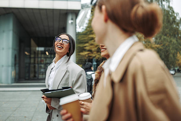 istock Three professional women walking in city with coffee cups during break 2246203609