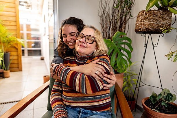 istock Mother and daughter embracing at home 2246204635
