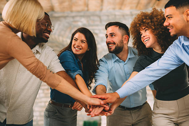 istock Diverse, multi-ethnic business team stacking hands in the center, showing unity, teamwork, and success in a modern office 2246205256