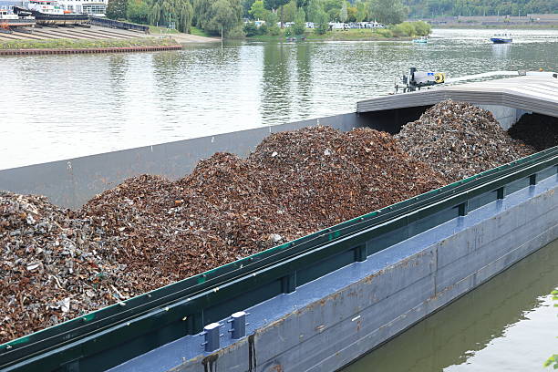 A cargo ship on the Moselle River is loaded with scrap metal.
