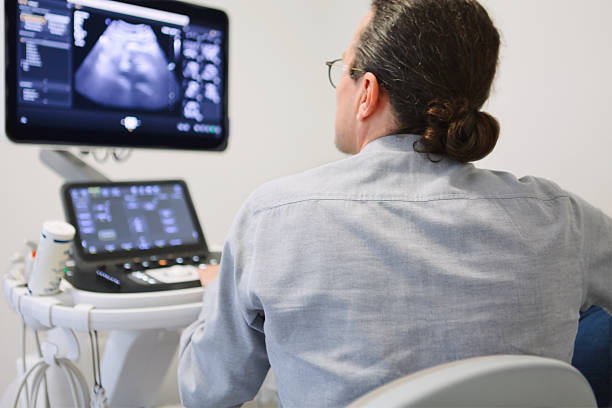 istock Male doctor using an ultrasound scanner to examine the screen. 2246207385