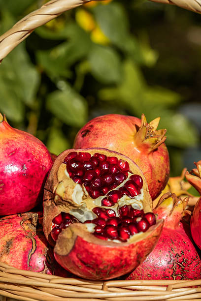 istock Close-up of pomegranates in basket with one open 2246210124