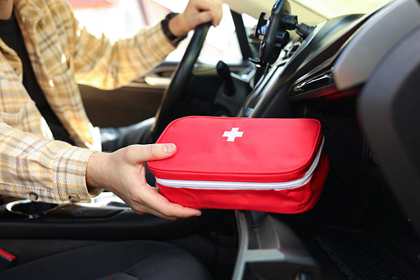 istock Man with first aid kit inside car, closeup 2246210555