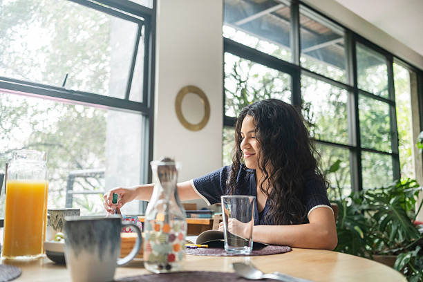 istock young woman eating breakfast before going to school 2246213328