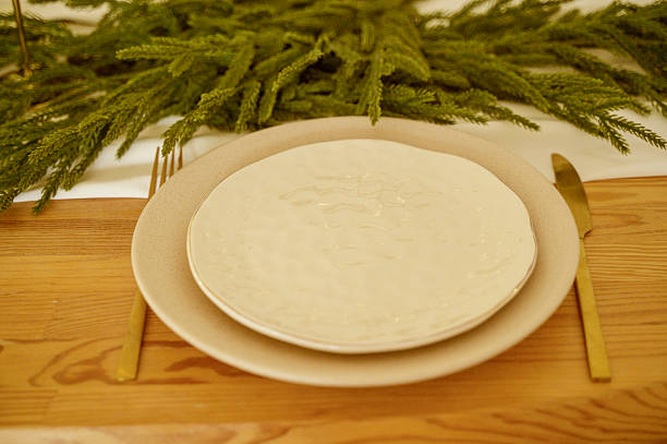 istock Beautiful arranged dining table for Christmas celebration, features elegant plates 2246213580