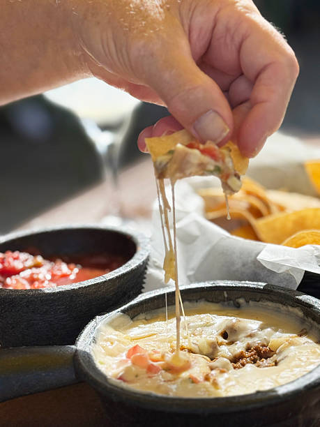 istock Delicious cheese dip served with crispy tortilla chips on a sunny patio 2246215056