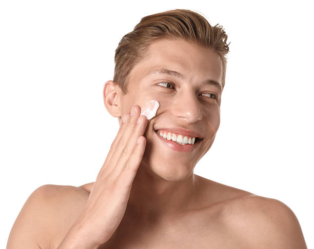 istock Handsome young man applying cream onto his face on white background 2246218756