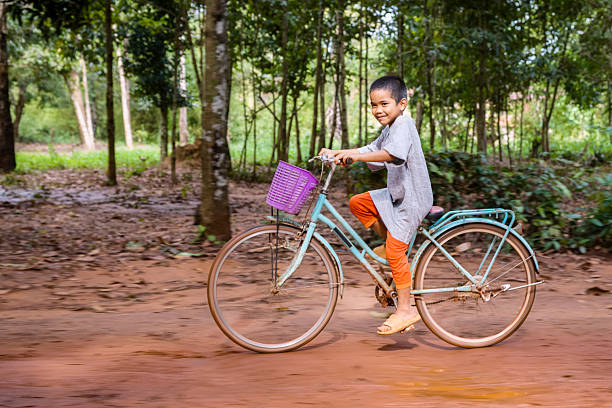 Tortuguero, Costa Rica, March 11, 2025: Local man riding his bike through the Caribbean town of Tortuguero, Costa Rica