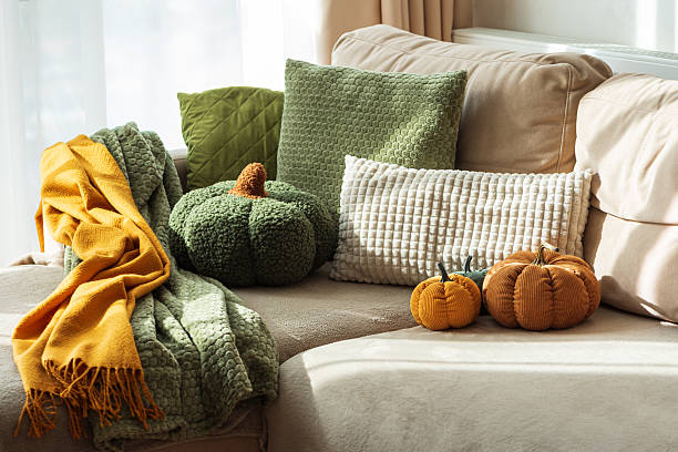 istock Autumn Sofa Styling with Textured Pillows, Fabric Pumpkins, and Cozy Blankets 2246224045