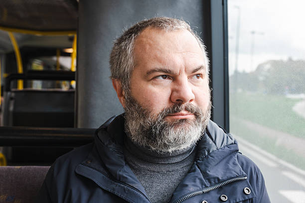 istock Senior European man sitting in tram 2246224450