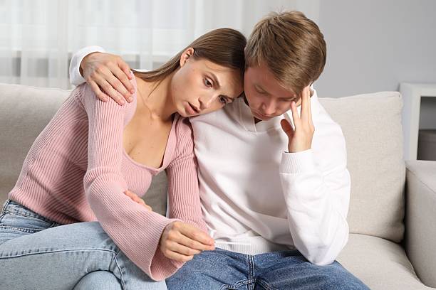istock Worried couple with pregnancy test on sofa at home 2246225192