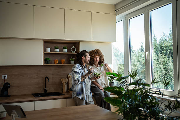 istock Couple eating healthy salad in modern kitchen 2246227883