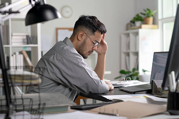 istock Businessman looking stressed from work, Businessman working at office feels overworked and burnout 2246228056