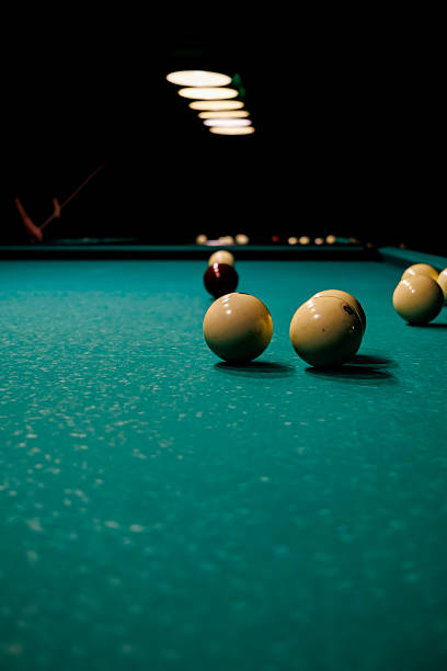 istock Billiard table with arranged balls under soft lamp lighting in a dark room, creating an atmosphere of solitude, focus, and quiet gameplay 2246228502