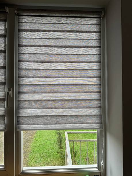 istock Contemporary roller blinds on window with green garden view 2246229906