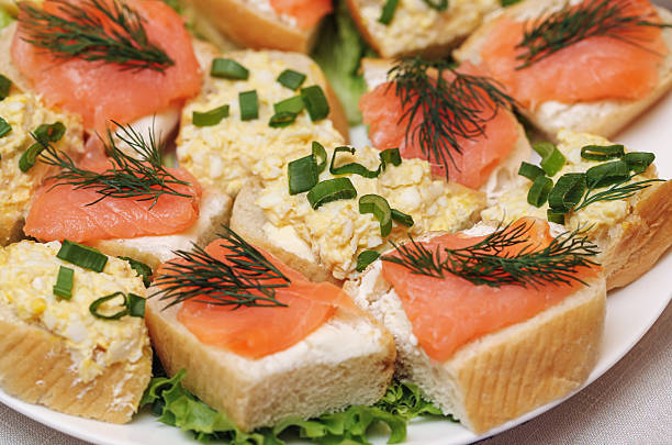 Fresh homemade appetizer served on white plate. Delicious snack or festive starter. Fingerfood background.