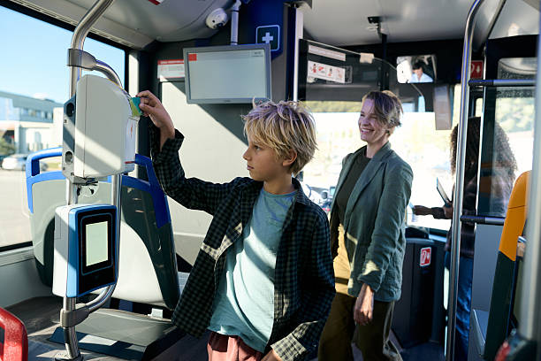 istock Boy using public transport card with mother on bus 2246230493