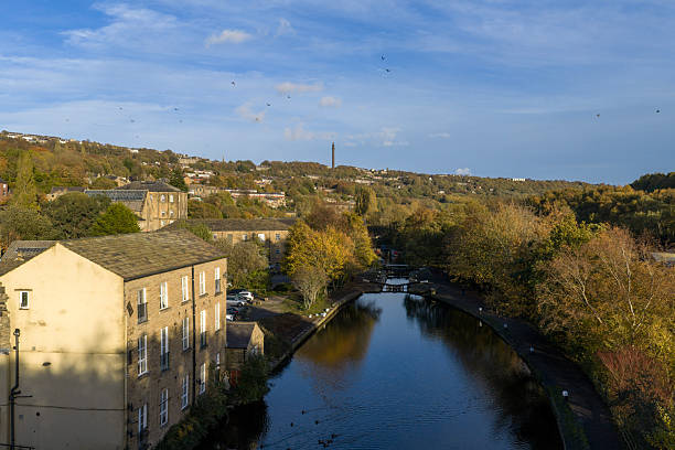 An aerial photograph of Sowerby Bridge in West Yorkshire, England. The photograph shows a canal in a part of the historic mill town on a bright autumn day. Sowerby Bridge is known to have the United Kingdoms deepest canal lock
