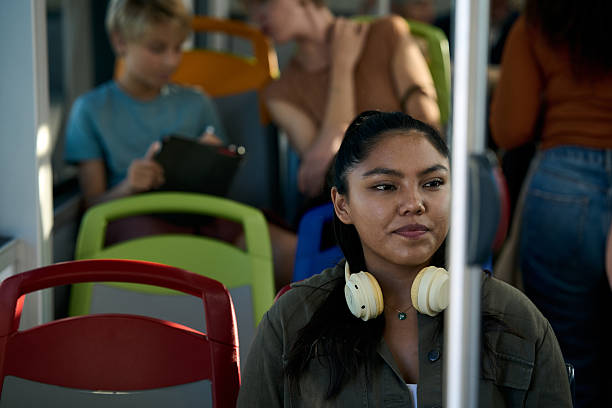 istock Young woman commuting on bus with headphones 2246230662