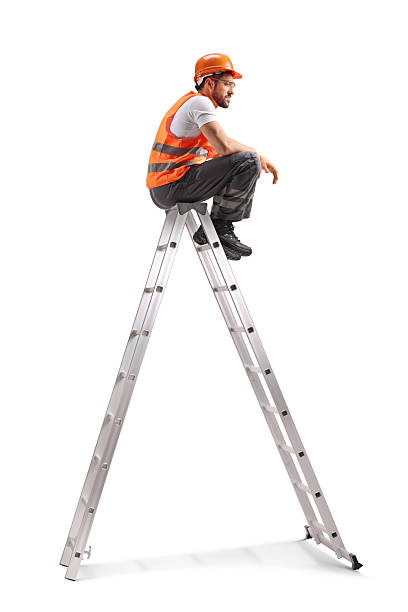 istock Repairman with a drilling machine on a ladder 2246230710