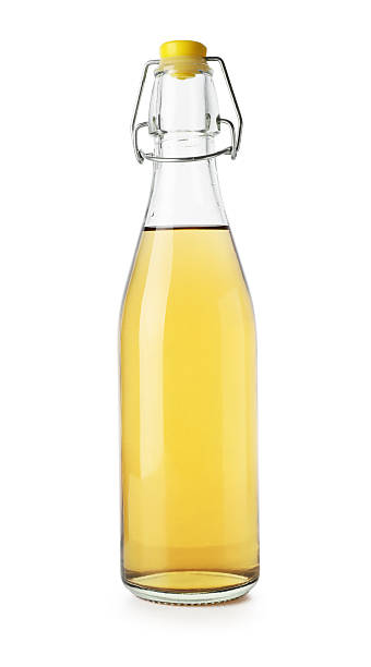 istock Delicious cider in glass bottle isolated on white 2246230762
