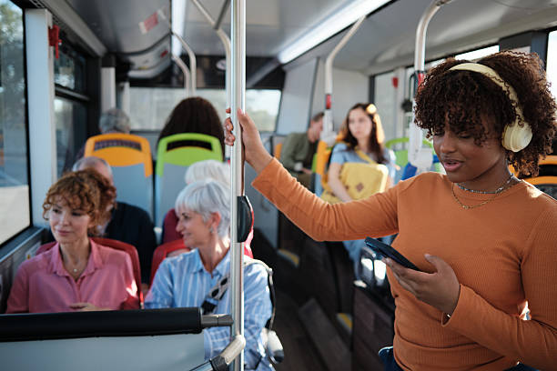 istock Young woman enjoying music while commuting on bus 2246230825