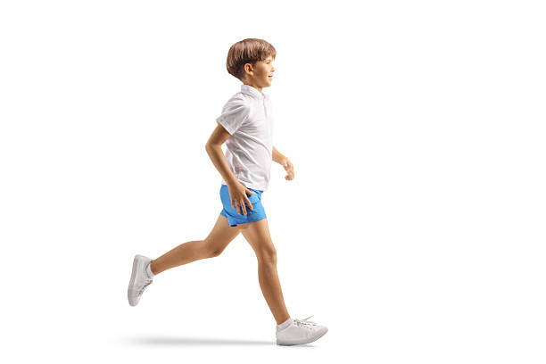 Full length profile shot of boy running isolated on white background