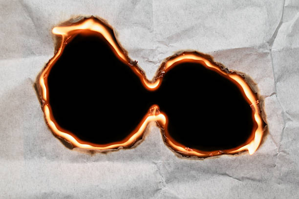 burning paper, glowing edge of paper on a black background