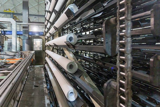 Toilet paper production at a factory. Specialized equipment with finished products in a large workshop.