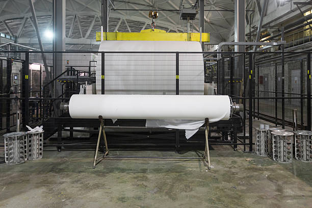 Jumbo rolls in a paper factory workshop. Specialized equipment for unwinding and winding rolls.