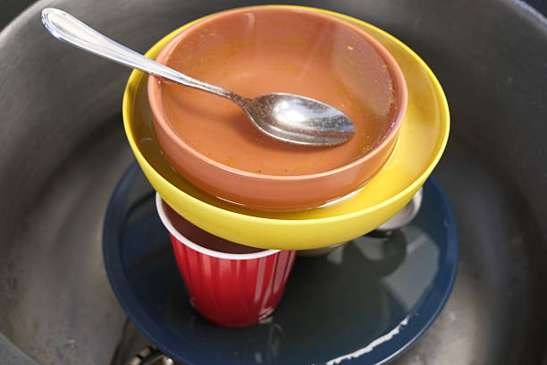 Stack of plates and bowls in sink