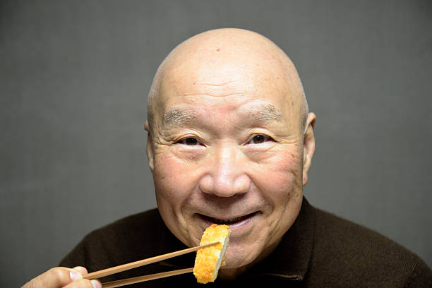 istock Seniors smiling as they eat Japanese pork dishes 2246233533