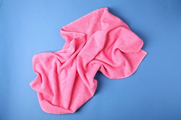 istock Pink terry towel on blue background, top view 2246233709
