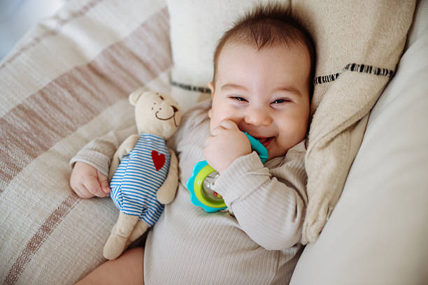 istock Male baby holds teether in his hand, development and massage of the gums. Close up teether 2246234177