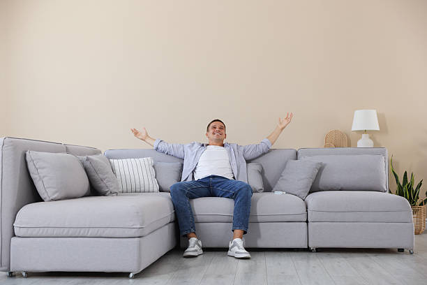 istock Young man relaxing on sofa at home 2246234389