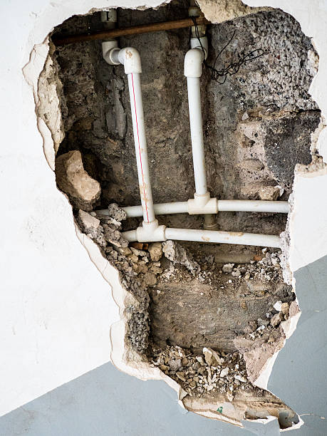 istock view of plastic pipework in hole of broken wall 2246234584
