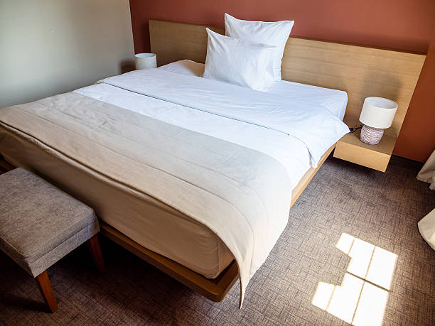 istock double bed covered with white linens in room 2246234588